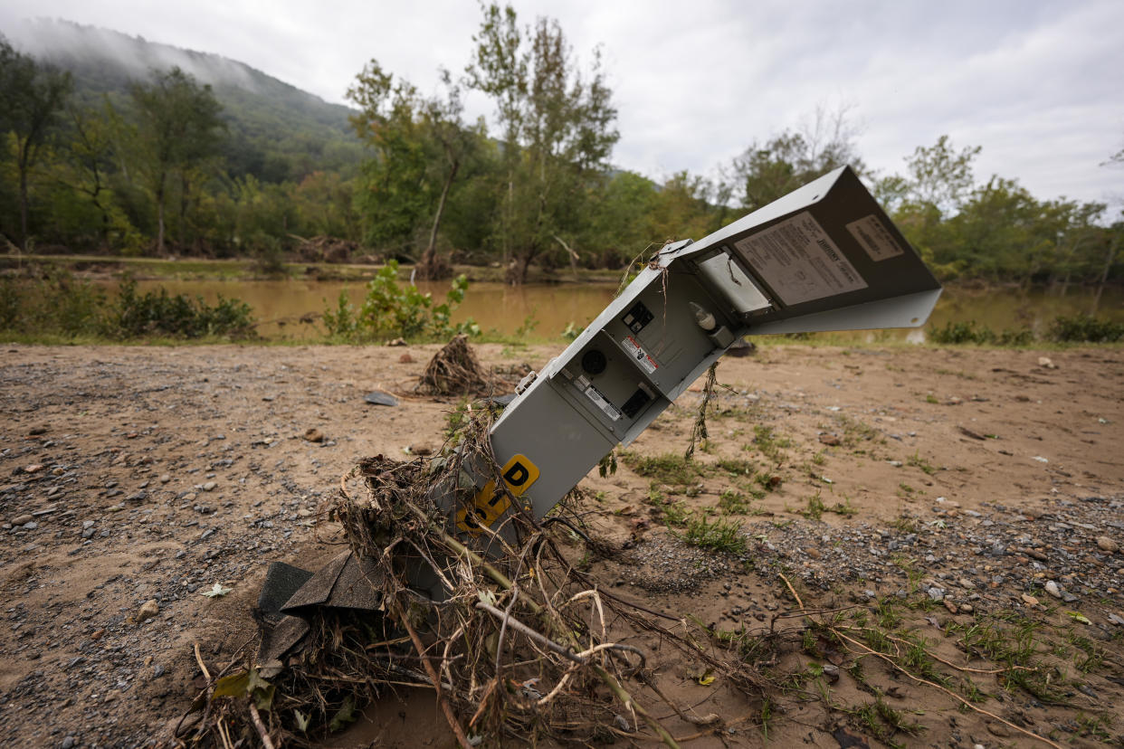 An electrical box is damaged after flash flooding in the aftermath of Hurricane Helene, Tuesday, Oct. 1, 2024, in Swannanoa, N.C. (AP Photo/Mike Stewart)