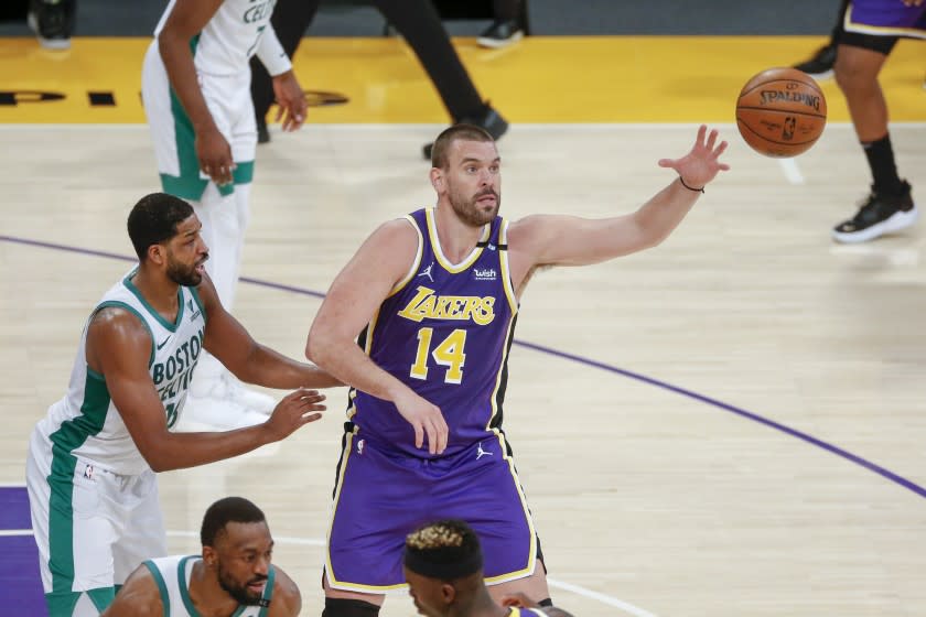 Los Angeles Lakers' Marc Gasol (14) is defended by Boston Celtics' Tristan Thompson (13) during the second half of an NBA basketball game, Thursday, April 15, 2021, in Los Angeles. (AP Photo/Ringo H.W. Chiu)