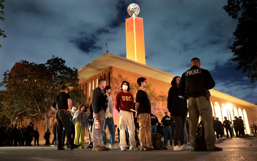 LOS ANGELES, CALIFORNIA - APRIL 24: Protestors are detained by LAPD officers who were trying to clear the USC campus during a demonstration against the war in in Gaza Wednesday. (Wally Skalij/Los Angeles Times)