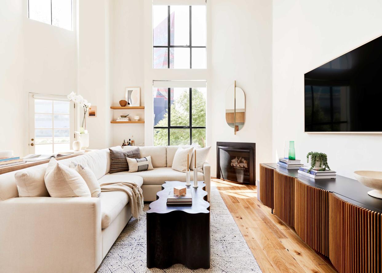  A white living room with modern furniture. 