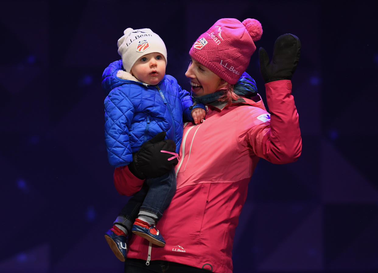 Kikkan Randall&nbsp;celebrates with her son, Breck, during a medal ceremony in Finland last year. (Photo: Matthias Hangst via Getty Images)