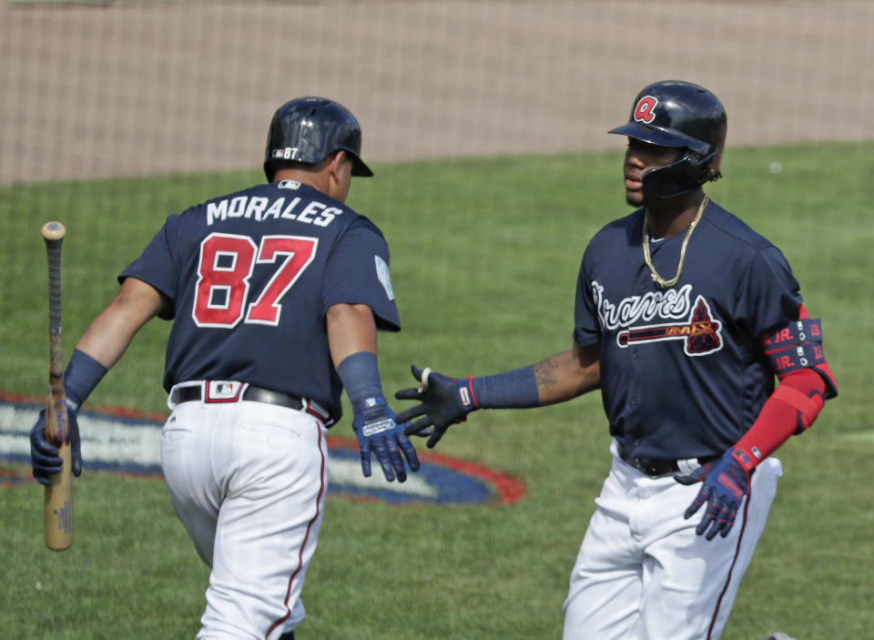 Atlanta Braves' Jonathan Morales, left, congratulates teammate Ronald Acuna Jr., right, on his sixth inning home run against the Houston Astros in a spring baseball exhibition game, Monday, March 4, 2019, in Kissimmee, Fla. (AP Photo/John Raoux)