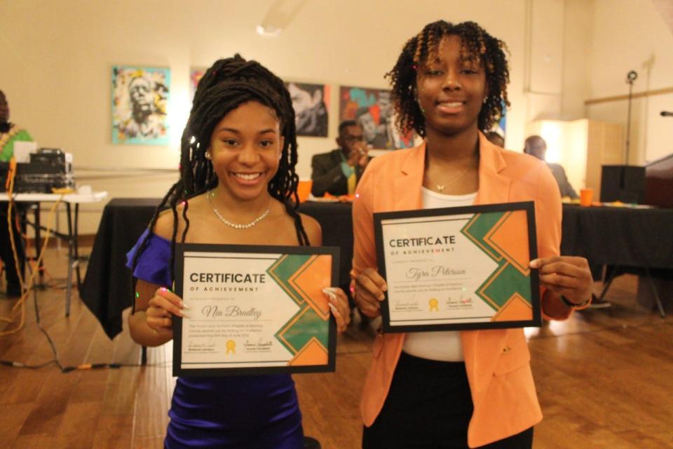 Nia Bradley, left, of Gainesville High School, and Tyra Peterson, right,  of Buchholz High School, both received $1,000 scholarships to attend Florida A&M University from the Alachua County chapter of the FAMU National Alumni Association during the chapter's annual Scholarship Gala on Saturday.