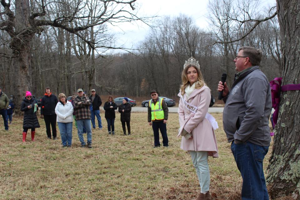 Reigning Maple King Jason Blocher speaks about his generational maple camp during the tree tapping ceremony at Sanner Maple near Rockwood on Saturday, while Queen Maple LXXV Ella Wheeler stands by.