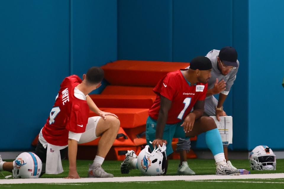 Jul 24, 2024; Miami Gardens, FL, USA; Miami Dolphins head coach Mike McDaniel talks to quarterback Tua Tagovailoa (1) during training camp at Baptist Health Training Complex. Mandatory Credit: Sam Navarro-USA TODAY Sports