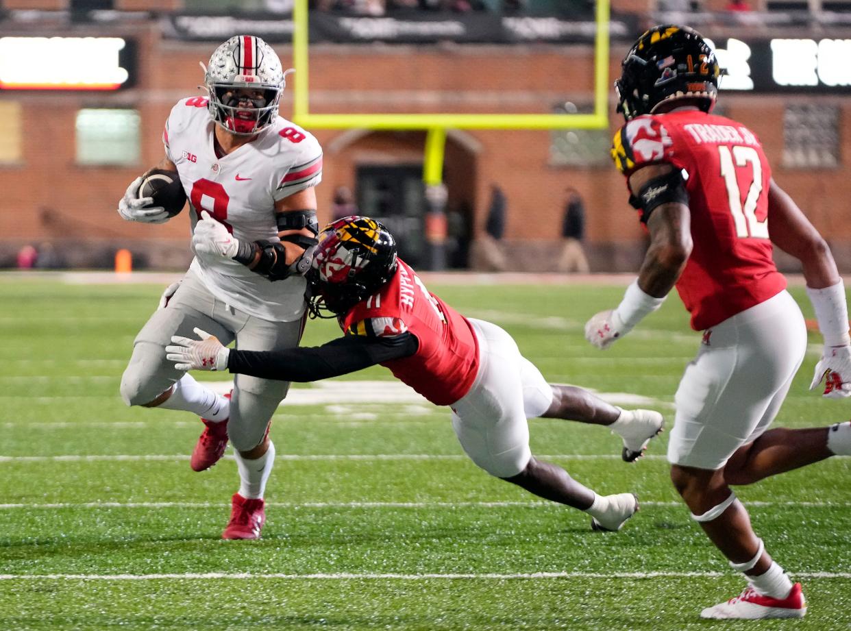 Nov 19, 2022; College Park, MD, USA; Ohio State Buckeyes tight end Cade Stover (8) gets tackled by Maryland Terrapins defensive back Tarheeb Still (4) after a catch in the third quarter in their Big Ten game at SECU Stadium. 