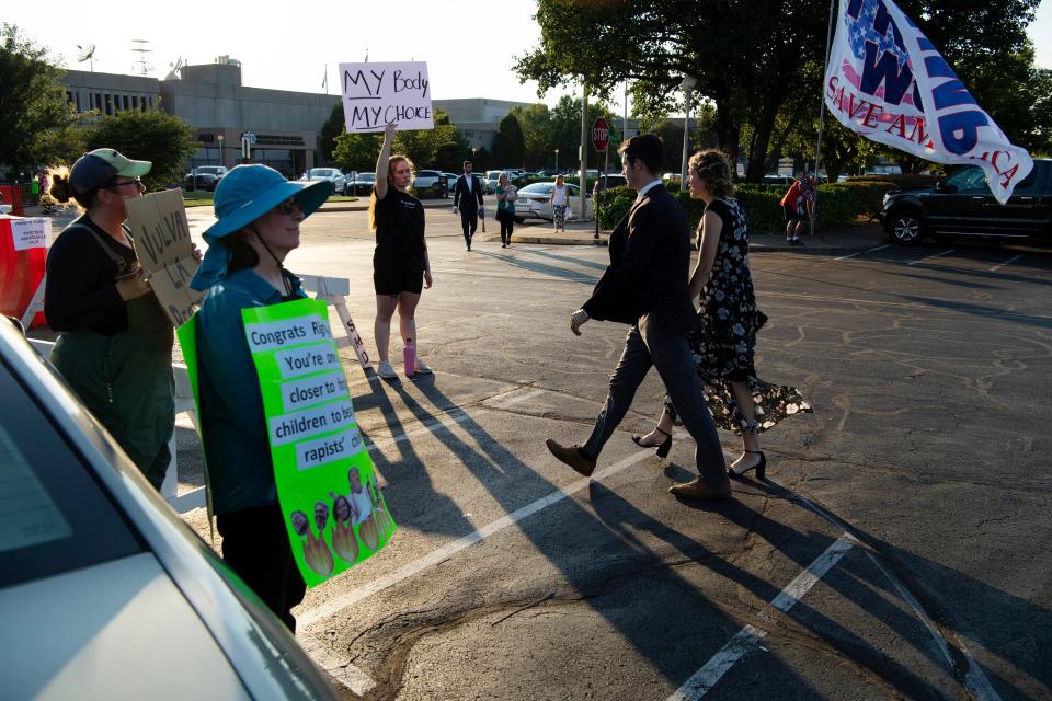 A handful of protesters made their silent voices heard with signage at the Right to Life of Southwest Indiana Annual Banquet outside the Old National Events Plaza in Evansville Thursday evening, Aug. 25, 2022.