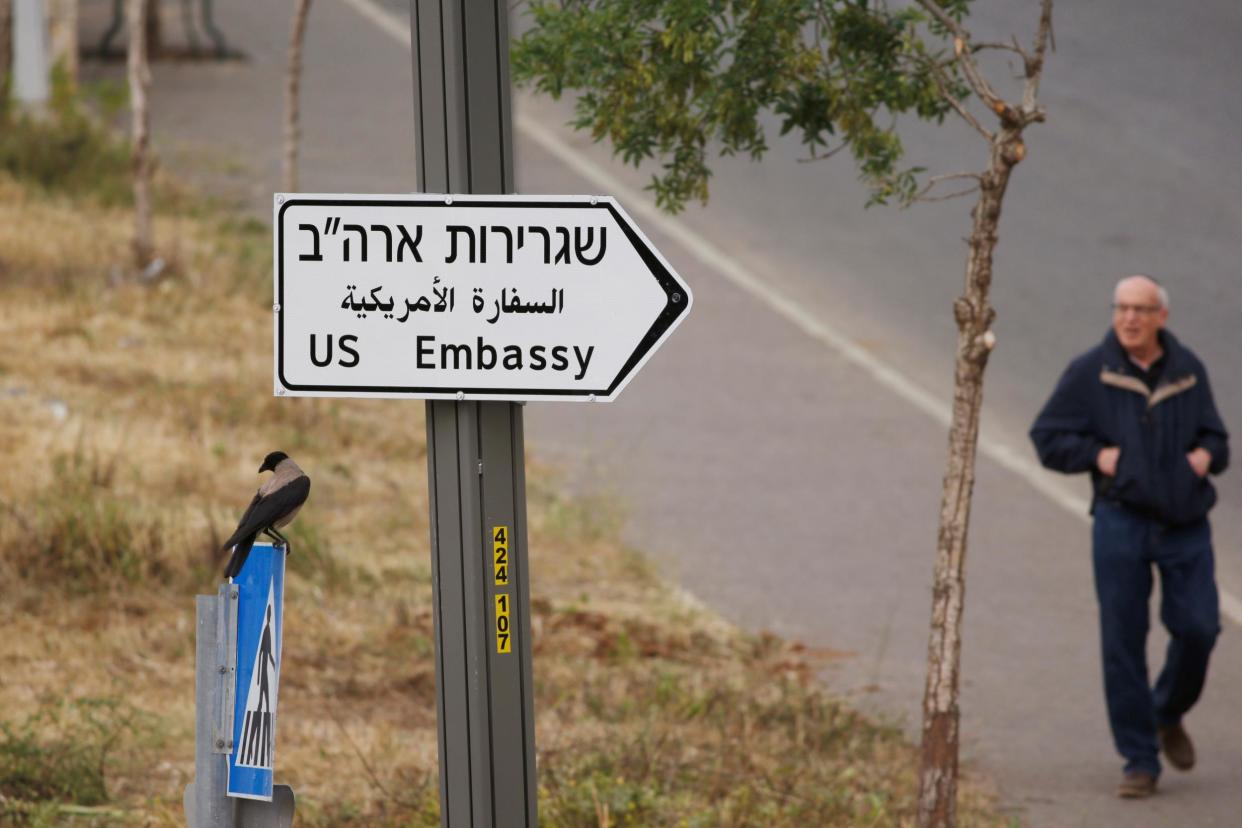 A man walks next to a road sign directing to the US embassy, in the area of the U.S. consulate in Jerusalem, May 7, 2018: Reuters