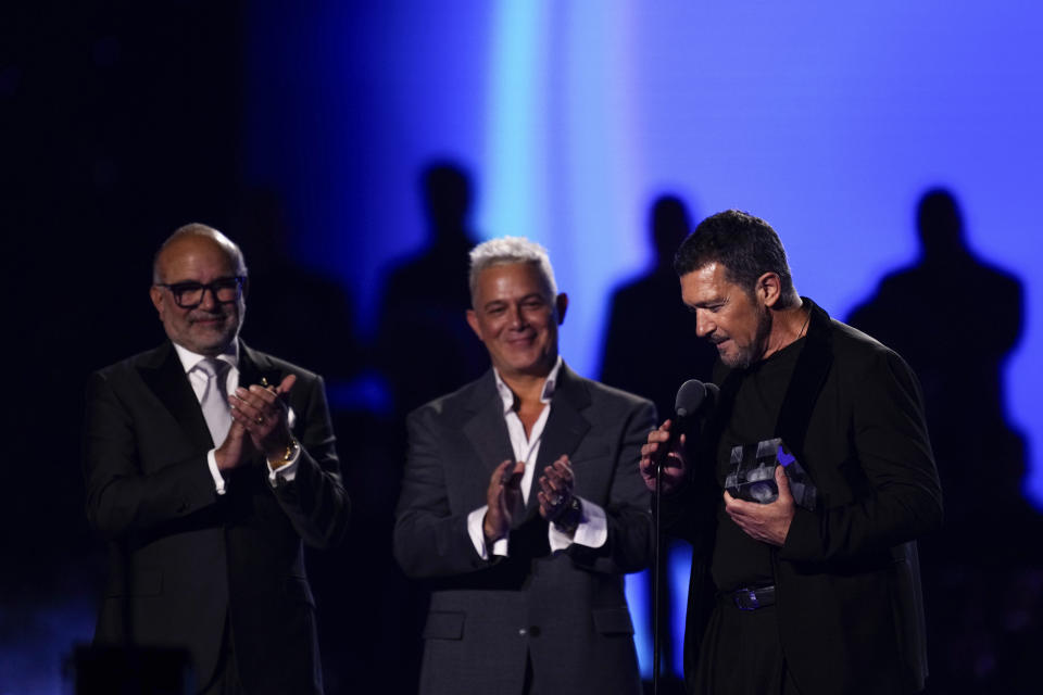 El director ejecutivo de La Academia Latina de la Grabación, Manuel Abud, izquierda, y Alejandro Sanz, centro, entregan el Premio de la Presidencia a Antonio Banderas durante la 24a entrega anual del Latin Grammy en Sevilla, España, el 16 de noviembre de 2023. (Foto Jose Breton/Invision/AP)