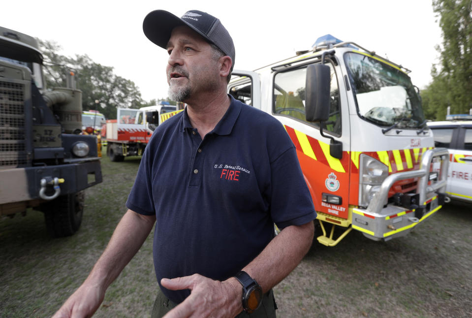 In this Jan. 10, 2020, photo, American firefighter Bill King arrives at a staging area at Candelo, Australia, before moving on to the fire brigade at Burragate. It seemed imminent to those hunkering at the fire station that "The Beast" would finally roar through. But on this night the wildfire only crept closer, prodding forward a few tentative fingers before going dormant again as the winds died. (AP Photo/Rick Rycroft)