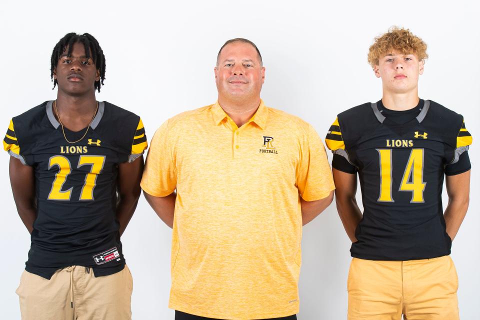 Red Lion football players Dakarai Dennis (27) and Chris Price (14) pose for a photo with head coach Jesse Shay during YAIAA football media day on Tuesday, August 1, 2023, in York.