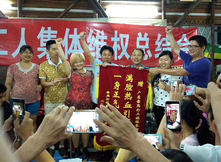 Lide shoe factory workers celebrate after winning concessions from their employer, following a strike at their factory in Panyu, south China's Guangdong province