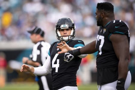 Dec 2, 2018; Jacksonville, FL, USA; Jacksonville Jaguars kicker Josh Lambo (4) celebrates his field goal with offensive guard Patrick Omameh (77) during the fourth quarter against the Indianapolis Colts at TIAA Bank Field. Mandatory Credit: Douglas DeFelice-USA TODAY Sports