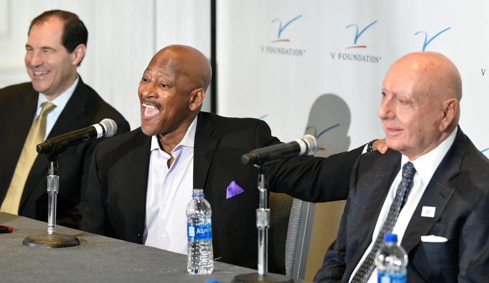 Rod Gilmore, in middle, a college football analyst for ABC and ESPN, who has battled multiple myeloma, a blood cancer, for the last six years received the V Foundation John Saunders Courage Award during The 17th Annual Dick Vitale Gala, at The Ritz-Carlton, Sarasota, on Friday, May 6, 2022.