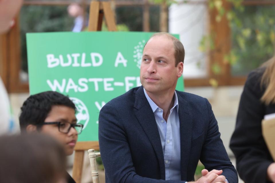 The Duke of Cambridge alongside children from The Heathlands School during a visit to the Royal Botanic Gardens in Kew (PA)