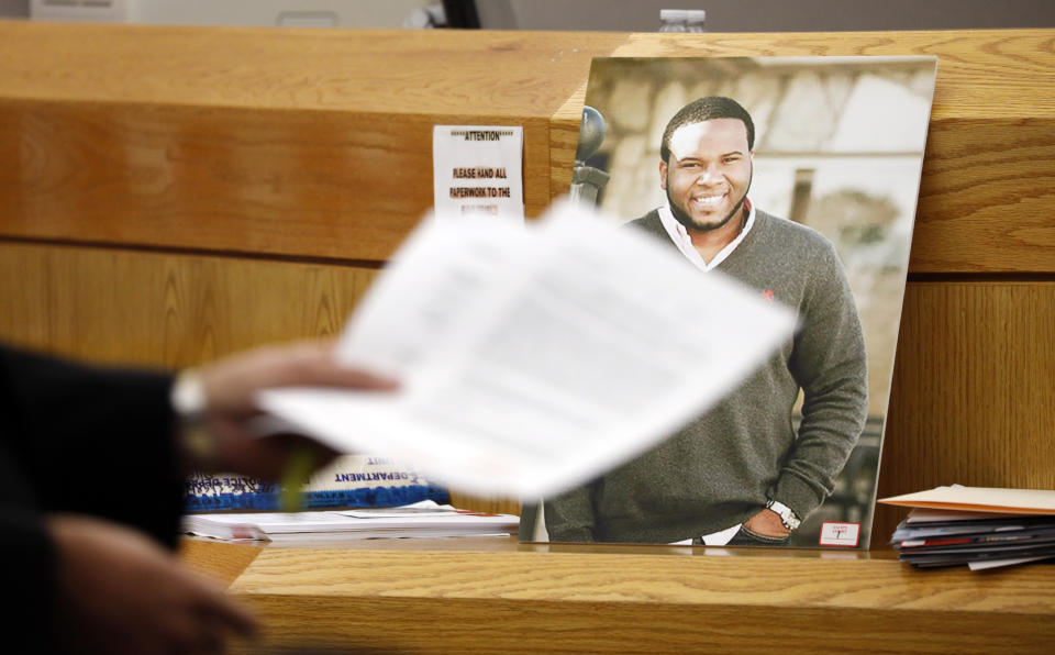 A photo of victim Botham Jean leans against Judge Tammy Kemp's bench during the murder trial of former Dallas police officer Amber Guyger, Tuesday, Sept. 24, 2019, in Dallas. Guyger is accused of shooting Jean, her unarmed black neighbor, in his Dallas apartment. (Tom Fox/The Dallas Morning News via AP, Pool)