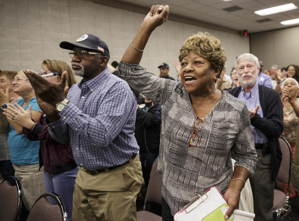 Betty Rowe cheers for Democratic candidate for governor Stacey Abrams during a town hall forum at the Dalton Convention Center on Wednesday, Aug. 1, 2018, in Dalton, Ga. Abrams is running against Republican candidate Brian Kemp in Georgia's November general election. (Doug Strickland/Chattanooga Times Free Press via AP)