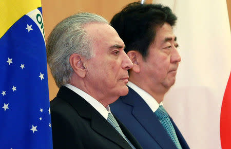 Brazil's President Michel Temer, left, listens to the Brazil's national anthem with Japanese Prime Minister Shinzo Abe, prior to their meeting at Abe's official residence in Tokyo, Oct. 19, 2016. REUTERS/Shizuo Kambayashi/Pool