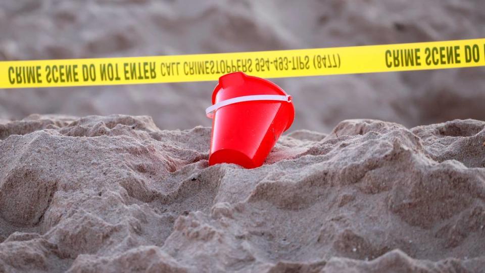 Yellow crime scene tape marks the area in a Lauderdale-by-the-Sea beach where a 7-year-old girl died on Tuesday, Feb. 20, 2024, after sand buried her at the bottom of a deep hole she and her brother had dug out on the beach, authorities said. Her brother was hospitalized.