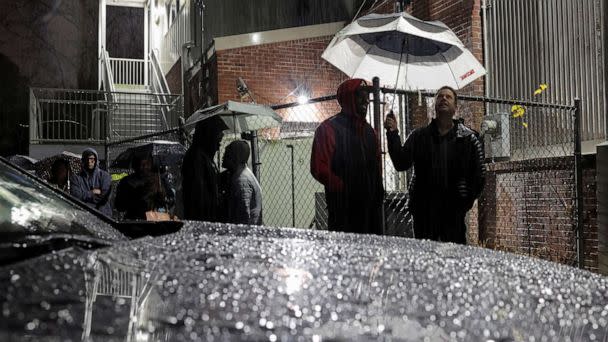 PHOTO: Local residents stand under the rain as they wait in line to cast their ballot during the runoff U.S. Senate election in Atlanta, December 6, 2022. (Carlos Barria/Reuters)