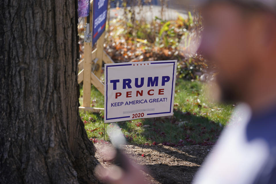 A President Donald Trump sign is posted in the front yard of Craig Rudisel as he speaks about Vigo County voting, Wednesday, Nov. 11, 2020, in Terre Haute, Ind. Rudisel supports Trump's position on guns, abortion and taxes. (AP Photo/Darron Cummings)