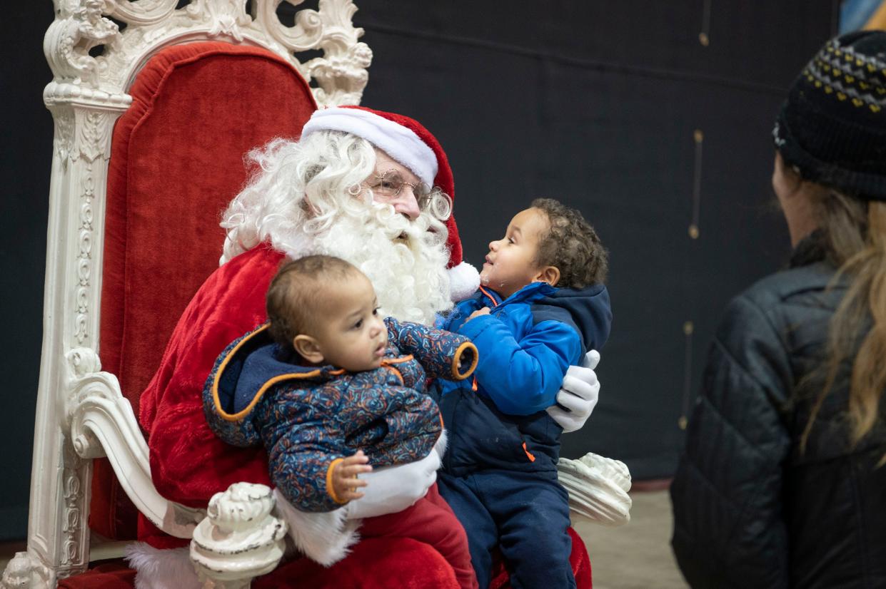 Battle Creek residents Wesley and Austin Jackson visit Santa during the Winter Wanderland event at Kellogg Arena on Friday, Dec. 2, 2022.