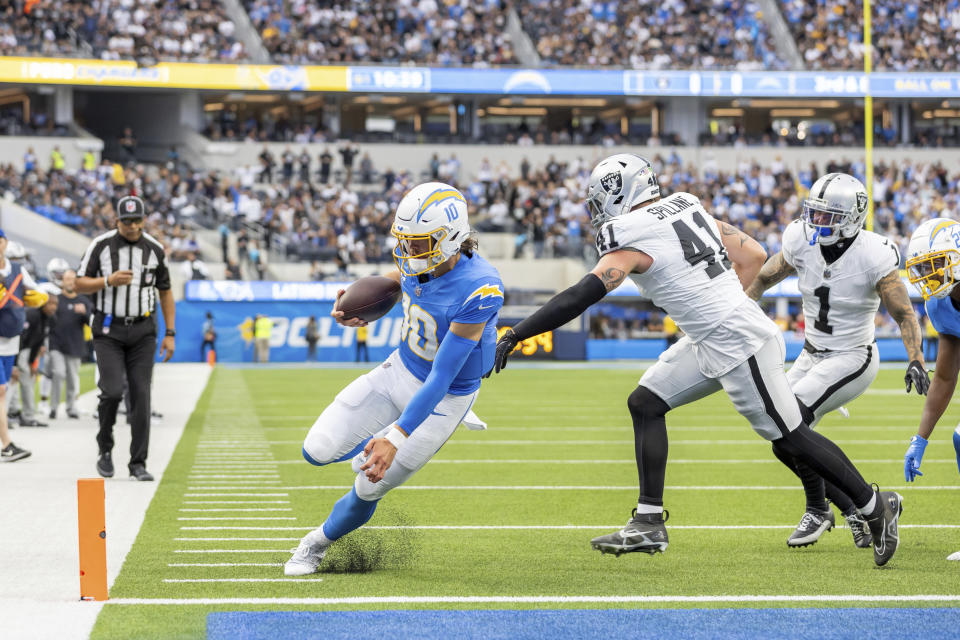 Los Angeles Chargers quarterback Justin Herbert (10) runs for a touchdown against the Las Vegas Raiders in an NFL football game, Sunday, Oct. 1, 2023, in Inglewood, Calif. (AP Photo/Jeff Lewis)