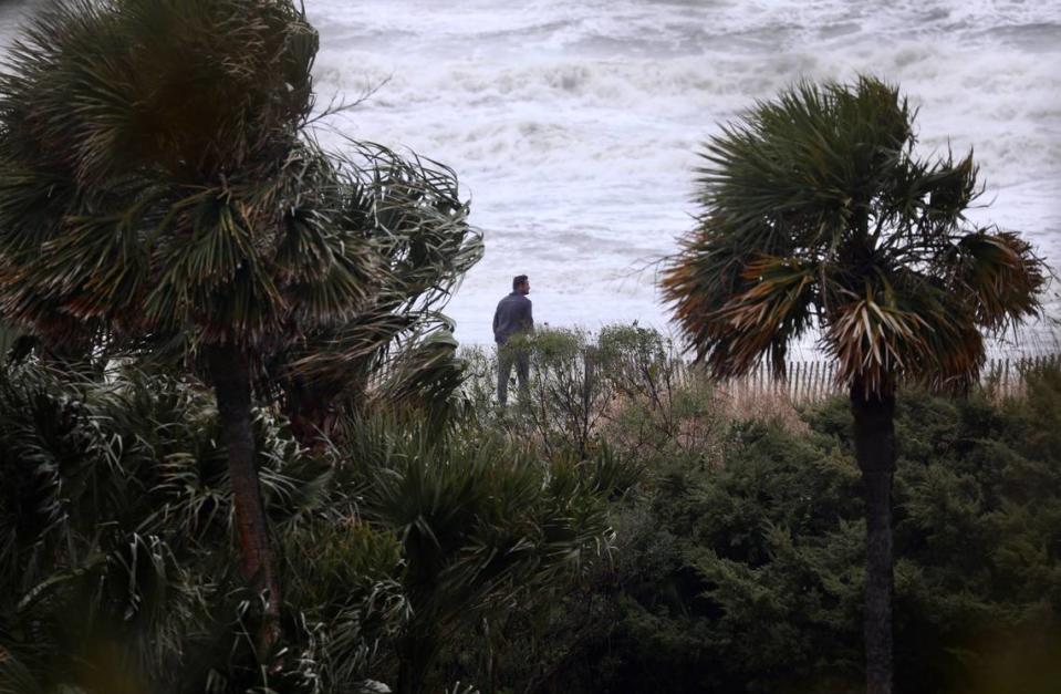 A  man leans into the wind watching the waves as severe storms bear down on Myrtle Beach, S.C., at 3:30 p.m. Jan. 9, 2024.