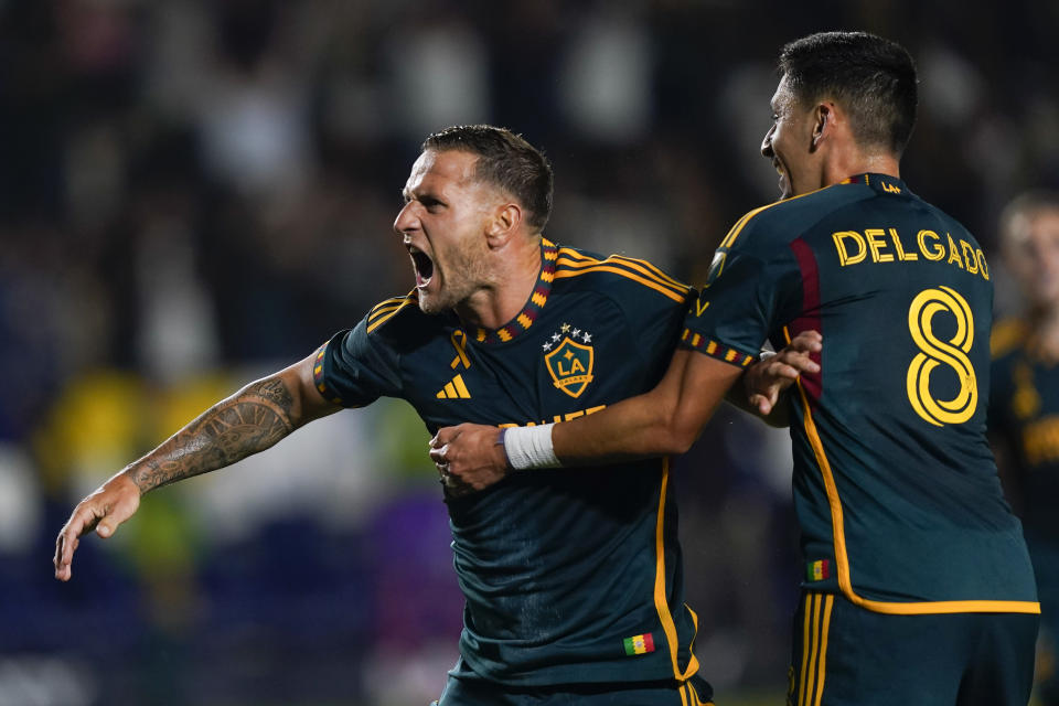LA Galaxy forward Billy Sharp, left, celebrates after scoring a goal against Minnesota United for a hat trick, during the second half of an MLS soccer match Wednesday, Sept. 20, 2023, in Carson, Calif. (AP Photo/Ryan Sun)