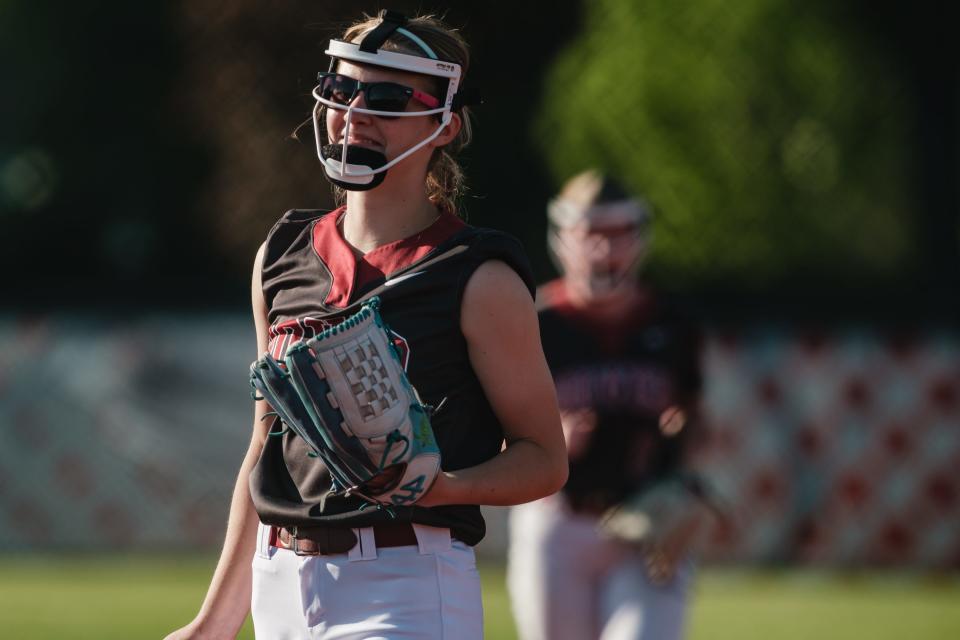 Dover softball's starting pitcher Kara Lint flashes a smile during the final outs during a DII Sectional Final game against Indian Valley, Friday, May 10 in Dover.