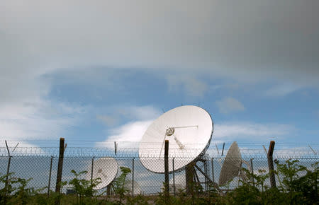 FILE PHOTO: Satellite dishes are seen at GCHQ's outpost at Bude, close to where trans-Atlantic fibre-optic cables come ashore in Cornwall, southwest England June 23, 2013. REUTERS/Kieran Doherty/File Photo