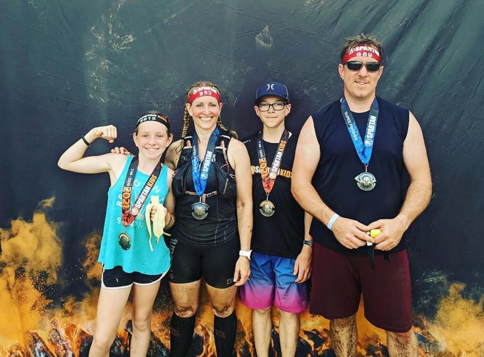 Former Gardner High cross-country and swimming standout Tina (Pellett) Bettez, second from left, has continued to compete in running by participating in Spartans races with her family: daughter Megan, son Bradley, and husband Mark.