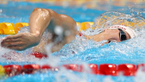 Canada's Penny Oleksiak, pictured, finished 10-100ths of a second shy of reigning Olympic champion Katie Ledecky's top time of 1:55.28 in qualifying for the 200-metre freestyle semifinals on Monday at Tokyo Aquatics Centre. (Kai Pfaffenbach/Reuters - image credit)