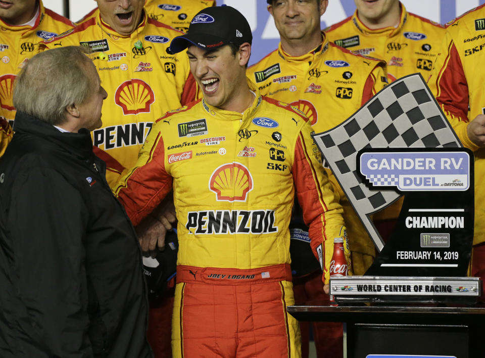 Edsel Ford II, left, congratulates Joey Logano, center, who had won the second of two qualifying auto races for the NASCAR Daytona 500 at Daytona International Speedway, Thursday, Feb. 14, 2019, in Daytona Beach, Fla. (AP Photo/Terry Renna)