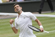 Serbia's Novak Djokovic celebrates after defeating Canada's Denis Shapovalov during the men's singles semifinals match on day eleven of the Wimbledon Tennis Championships in London, Friday, July 9, 2021. (AP Photo/Kirsty Wigglesworth)