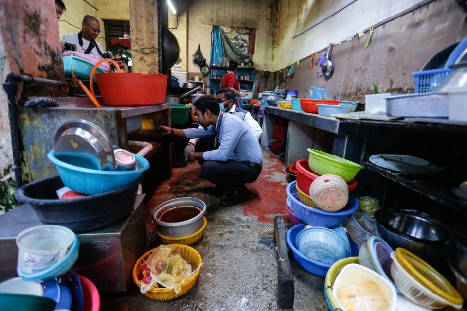 Enforcement officers from the Penang Island City Council conduct checks on an eatery in George Town February 26, 2020. — Picture by Sayuti Zainudin