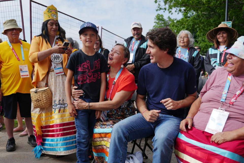 Prime Minister Justin Trudeau, second from right, and his son Hadrien, third from left, are greeted prior to Canoe/Kayak competition at the North American Indigenous Games 2023 in Halifax on Monday.