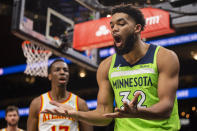 Minnesota Timberwolves center Karl-Anthony Towns (32) reacts to foul by Atlanta Hawks forward Onyeka Okongwu (17) during the second half of an NBA basketball game Wednesday, Jan. 19, 2022, in Atlanta. (AP Photo/Hakim Wright Sr.)