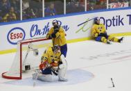 Sweden's goalie Oscar Dansk, Robert Hagg (C), and Elias Lindholm (R) react to losing to Finland in overtime of their IIHF World Junior Championship gold medal ice hockey game in Malmo, Sweden, January 5, 2014. REUTERS/Alexander Demianchuk (SWEDEN - Tags: SPORT ICE HOCKEY)