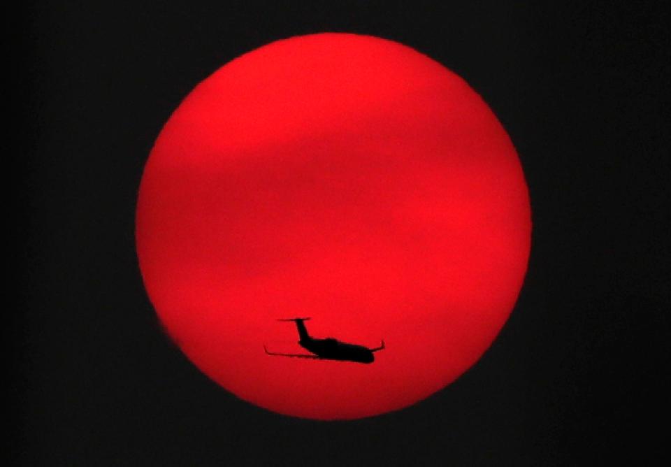 Wm. Glasheen took third place in the artistic photo category for a photo of an airplane crossing in front the setting sun on Tuesday, Sept. 15, 2020, near Appleton, Wis. The sun is seen through the filter of skies made hazy by smoke from forest fires on the West Coast.