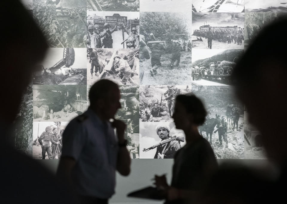 People stand in the exhibition during a press preview of the special exhibition 'The Fuehrer Adolf Hitler is dead - Attempted Assassination and coup d'etat on 20 July 1944.' by the Bundeswehr Museum of Military History in Dresden, Germany, Wednesday, July 3, 2019. The exhibition examines the background to the plot and shines a spotlight on 14 of the main conspirators. Some of the scenery used in the Hollywood movie Valkyrie and a photo collage provide visitors with a strong visual sense of these momentous events .The exhibition starts on July 5, 2019 and lasts until Dec. 3, 2019. (AP Photo/Jens Meyer)