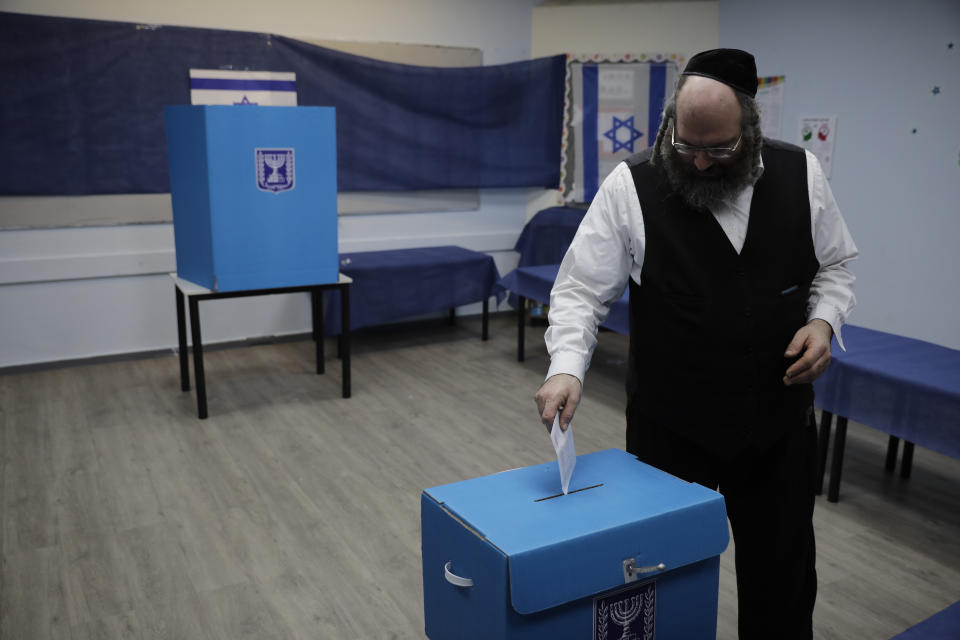 A man votes in Rosh Haayin, Israel, Tuesday, Sept. 17, 2019. Israelis began voting Tuesday in an unprecedented repeat election that will decide whether longtime Prime Minister Benjamin Netanyahu stays in power despite a looming indictment on corruption charges. (AP Photo/Sebastian Scheiner)