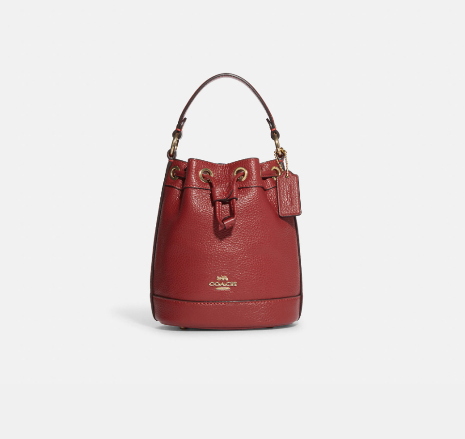 Dempsey Drawstring Bucket Bag 15 in 1941 red (Photo via Coach Outlet)