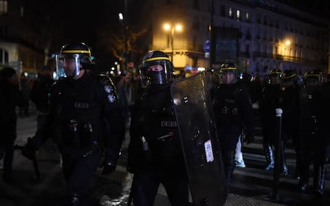 CRS riot police stand as protestors gather in front of the Bouffes du Nord theatre in Paris on where the French President attended a play - Credit: &nbsp;LUCAS BARIOULET/AFP