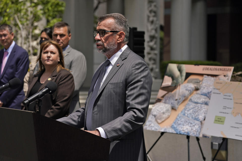 DEA Special Agent in Charge Bill Bodner, center, addresses the media outside the Edward R. Roybal Federal Building, Thursday, May 13, 2021, in Los Angeles. Federal authorities say they have arrested at least 10 suspected drug dealers accused of selling fentanyl and other opioids that led to overdose deaths. (AP Photo/Marcio Jose Sanchez)