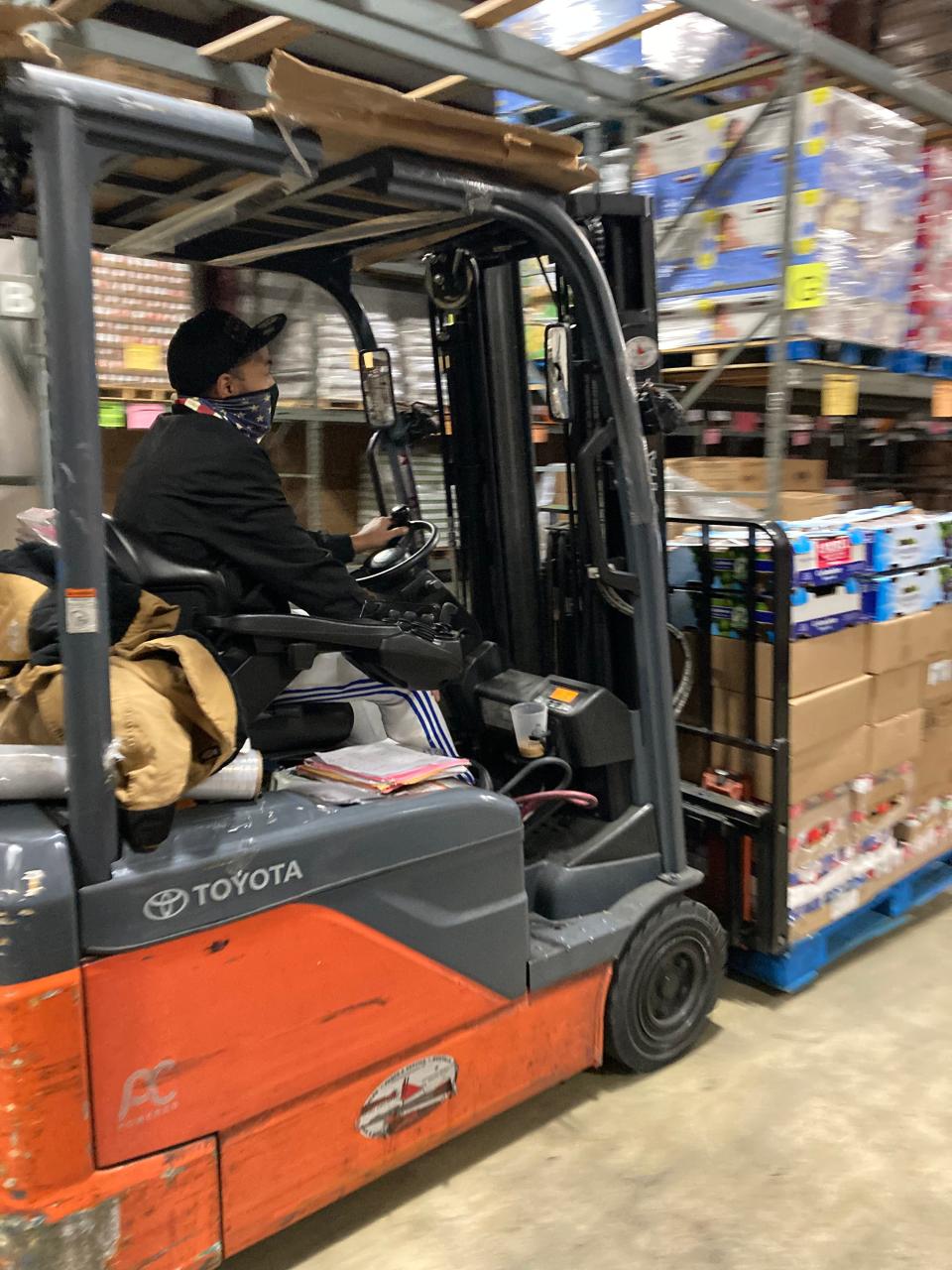 Brendan LaFavor drives a forklift in the warehouse of Golden Harvest Food Bank in Augusta.