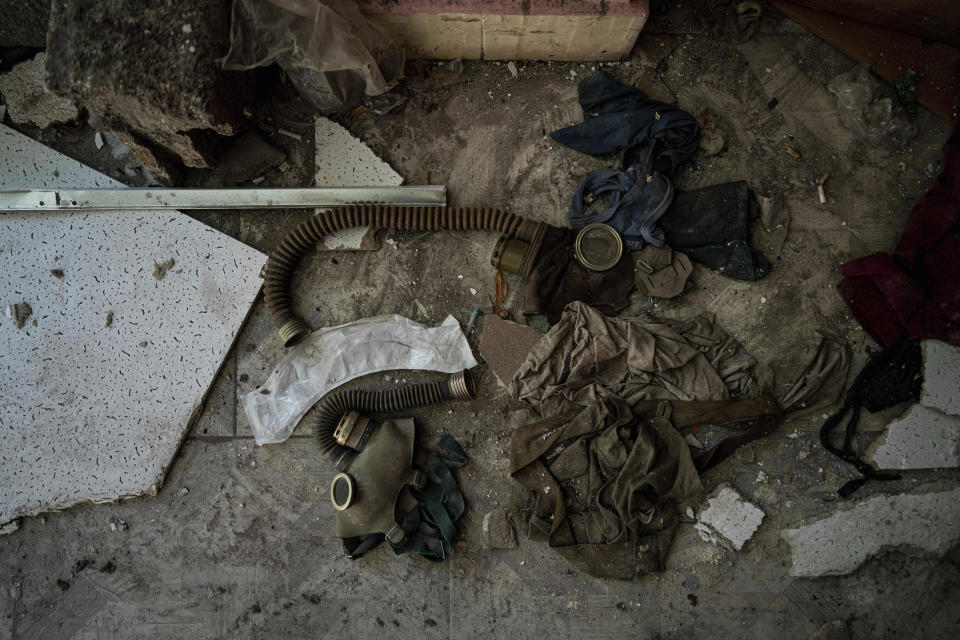 A gas mask lies on the floor of a school which had been used by Russian forces as a headquarters and where civilians said they were held and tortured, in Izium, Ukraine, Wednesday, Sept. 21, 2022. Civilians who had been detained said Russian soldiers used gas masks on them during torture. (AP Photo/Evgeniy Maloletka)