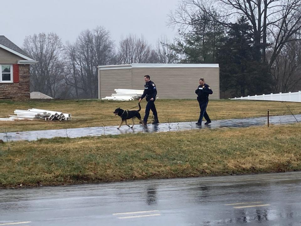 Middletown police use a sniffer dog to inspect the Langhorne-Yardley Road property of Curtis G. Smith on which several unapproved additions were built in 2022 and 2023 without permits.