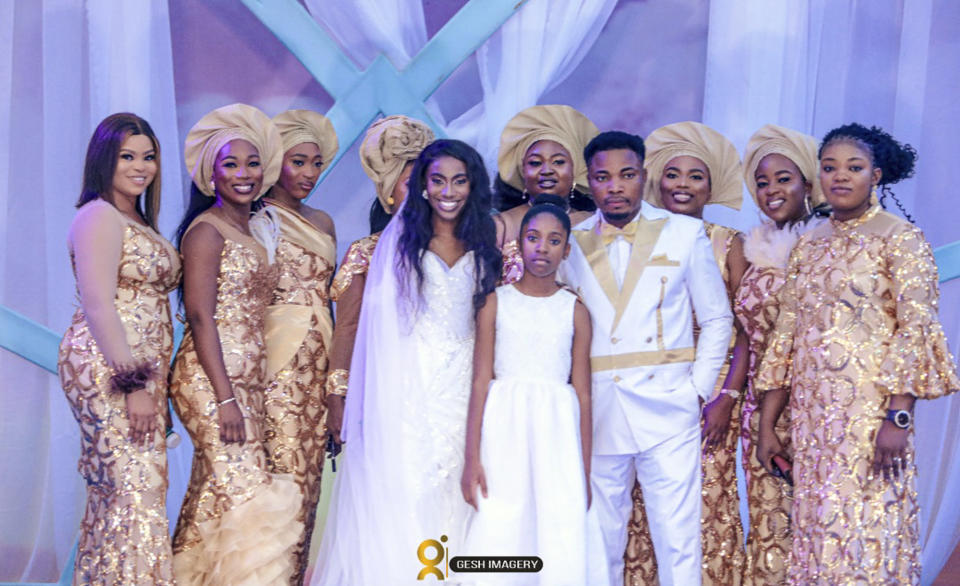 In this photo provided by Gesh Creatives, Eunice Dwumfour, center left, stands with daughter Nicole, 11, husband and fellow pastor Peter Ezechukwu and other loved ones at her Nov. 24, 2022 wedding ceremony at Champions Royal Assembly in Abuja, Nigeria. The 30-year-old Dwumfour, a Sayreville, New Jersey councilwoman, was gunned down as she arrived home in Sayreville on Feb. 1 by an unknown assailant. (Gesh Creatives Photo via AP)
