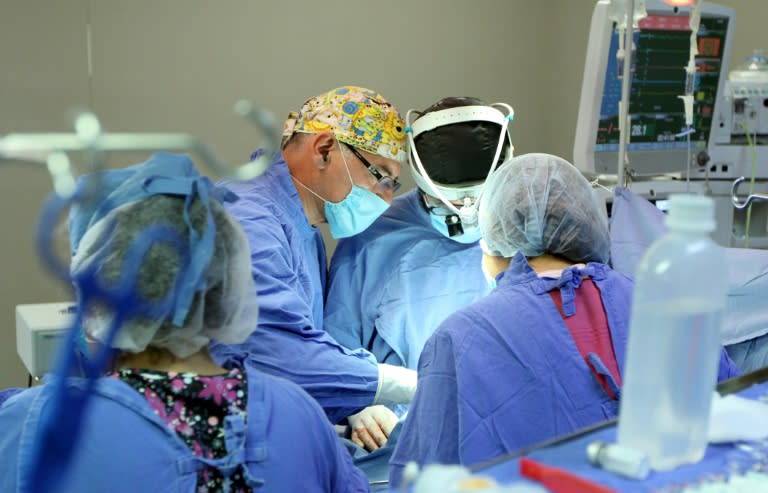 Handout picture released by the Mexican Social Security Institute (IMSS in Spanish) press office showing Dr. David Arellano (C) conducting a surgery at the La Raza hospital in Mexico City, on September 14, 2017. When the September 19 quake shook Mexico City this year, Arellano was performing an open heart surgery in a newborn. Arellano saw from the surgery room the dust cloud left by a collapsing building and did what he had done on September 7 when another earthquake struck him during a surgery on a nine-year-old girl, controlling fear and focusing on his work